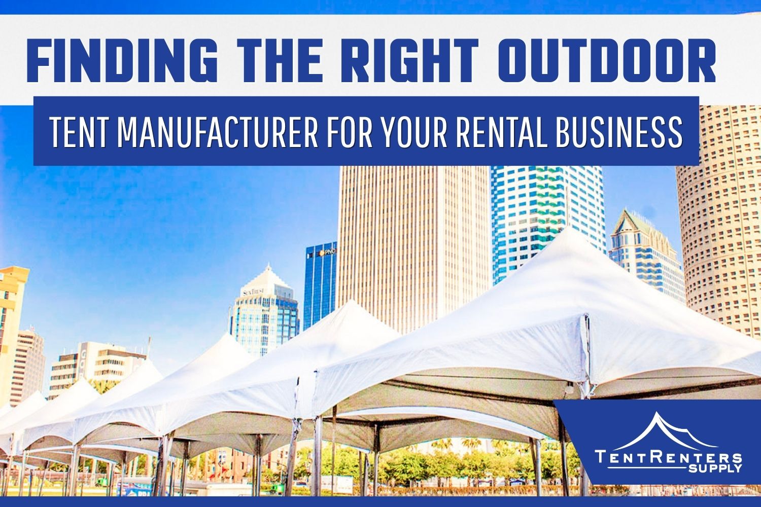White frame party tents set up along a waterfront with a city skyline of high-rise buildings in the background